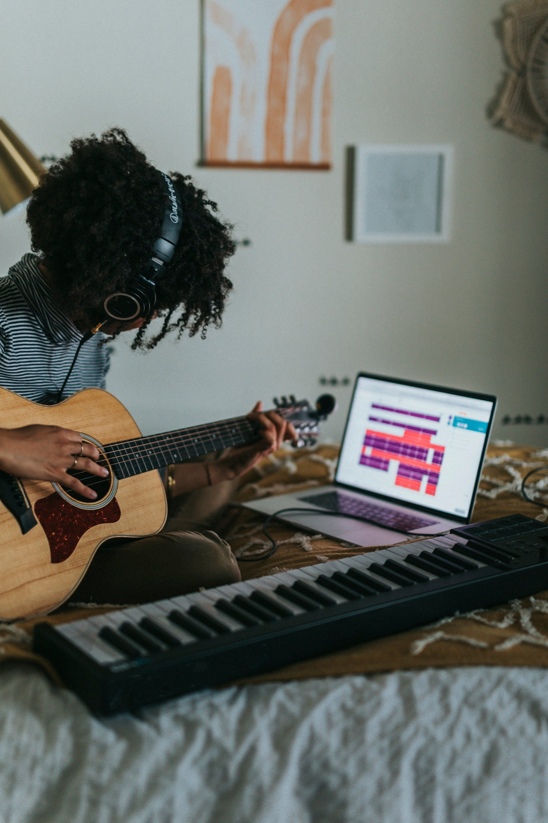 woman playing brown acoustic guitar