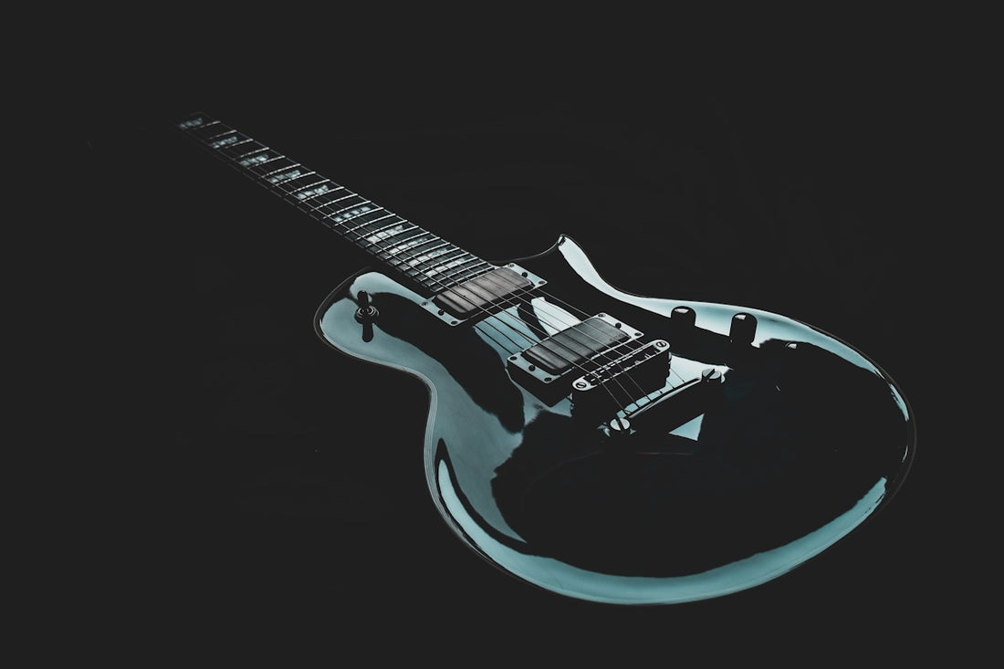 A black and blue electric guitar on a black background