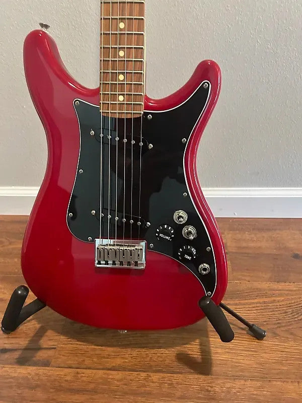 Used Fender Player Lead II in Crimson Red Transparent with a sleek body and distinctive double cutaway design.