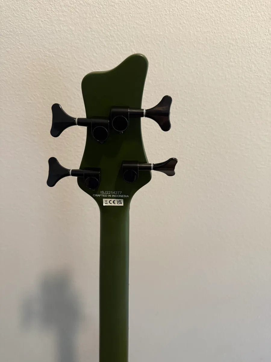 Jackson X Series Spectra Bass SBX IV in Matte Army Drab, showcasing body shape and details of the electric bass guitar.