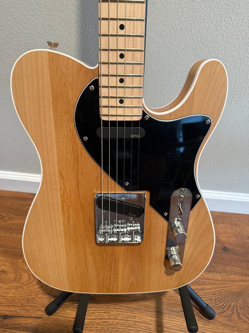 Custom Telecaster guitar by Palm Harbor Music featuring a sleek design and vibrant finish on a wooden body.