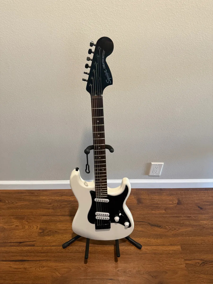 Used Squier Contemporary Stratocaster in pearl white finish, showcasing sleek body shape and chrome hardware.