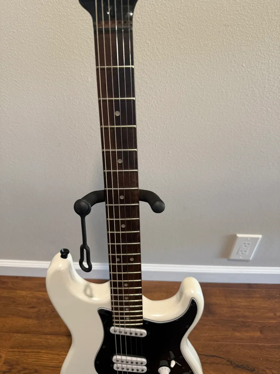Used Squier by Fender Contemporary Stratocaster in pearl white finish, showcasing its sleek body and elegant design.