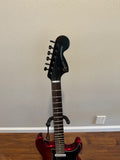 Used Squier Contemporary Stratocaster guitar in Sunset Metallic finish, showcasing its sleek body and vibrant color.